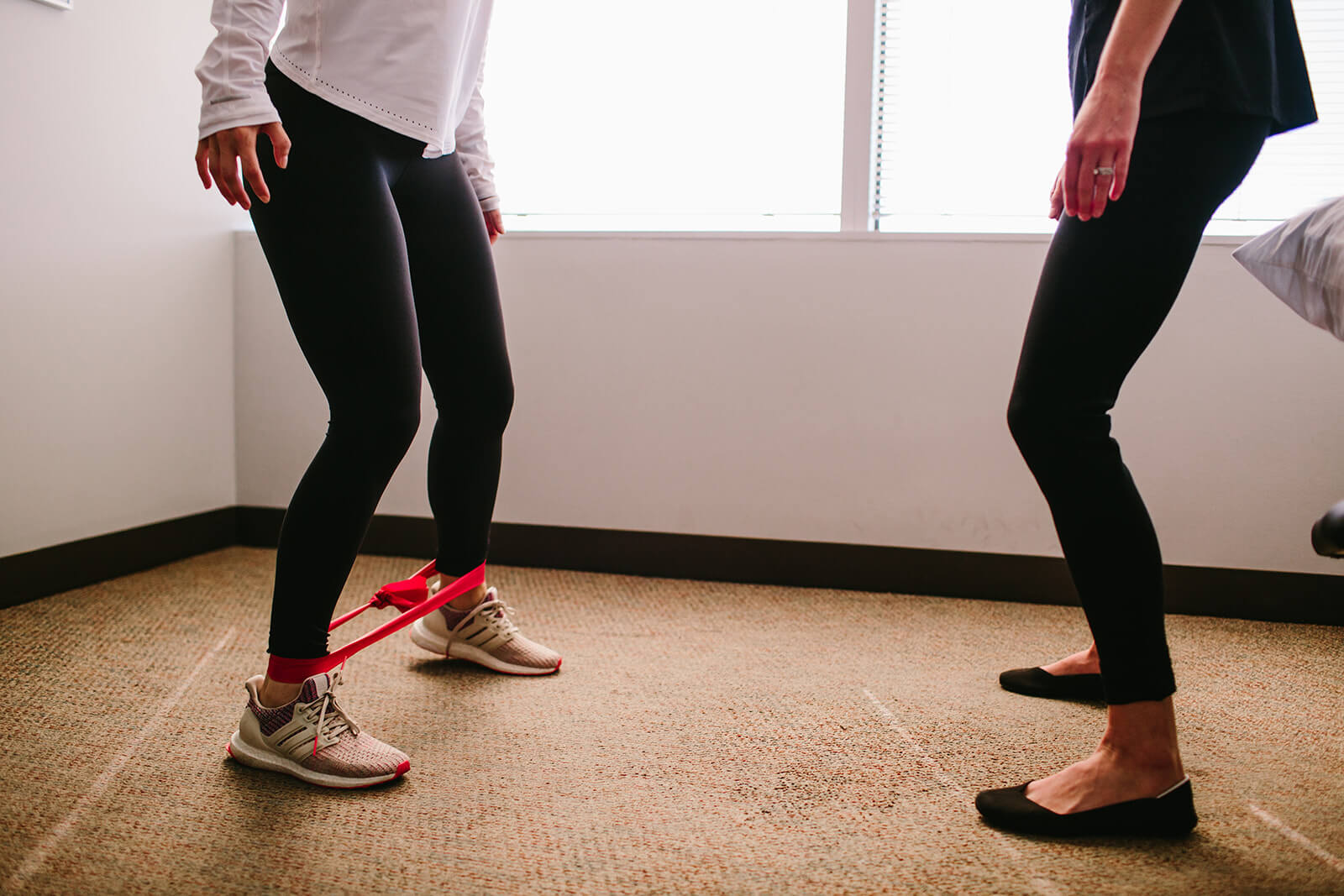 Patient and therapist using resistance bands training for sports injury