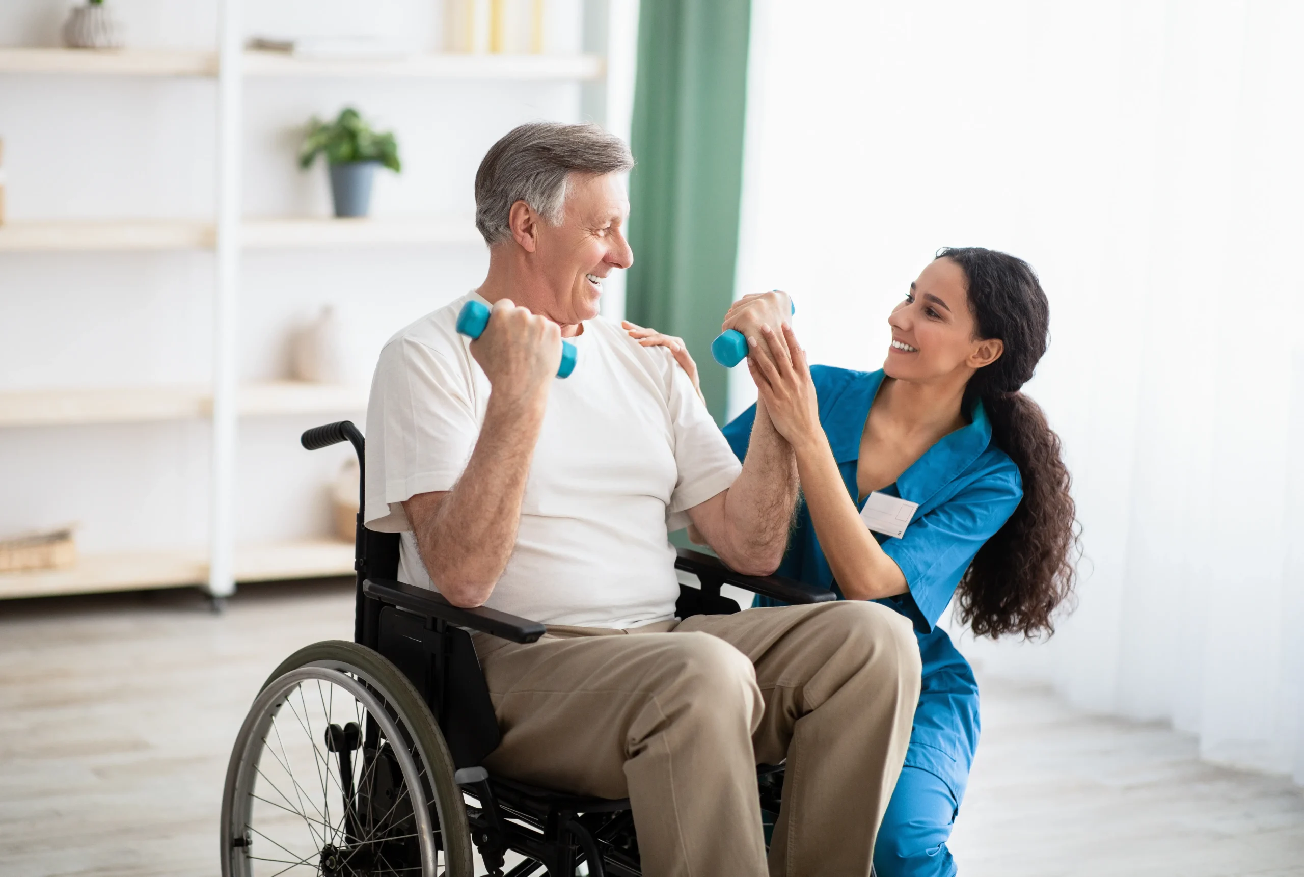 physical therapy cost denver (1) Doctor helping disabled elderly man in wheelchair to work out with dumbbells, to recover from injury at health centre
